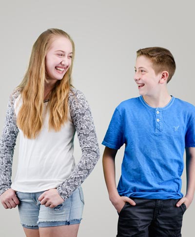 two siblings laughing at each other